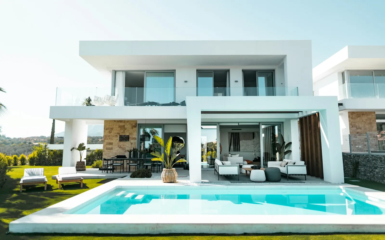 White modern villa with a lawn and a swimming pool